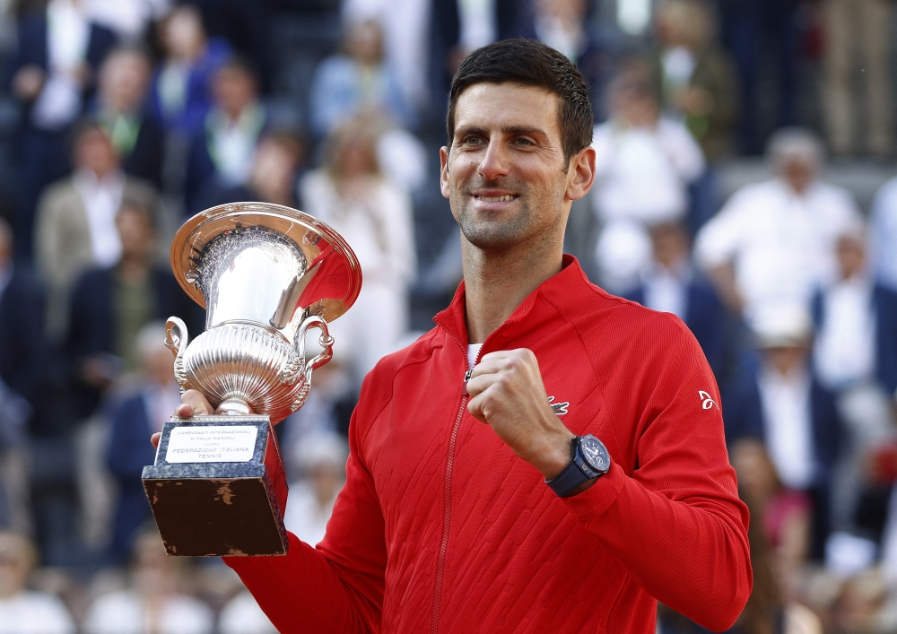 Serbia's Novak Djokovic celebrates with the trophy after winning the final against Greece's Stefanos Tsitsipas REUTERS/Guglielmo Mangiapane