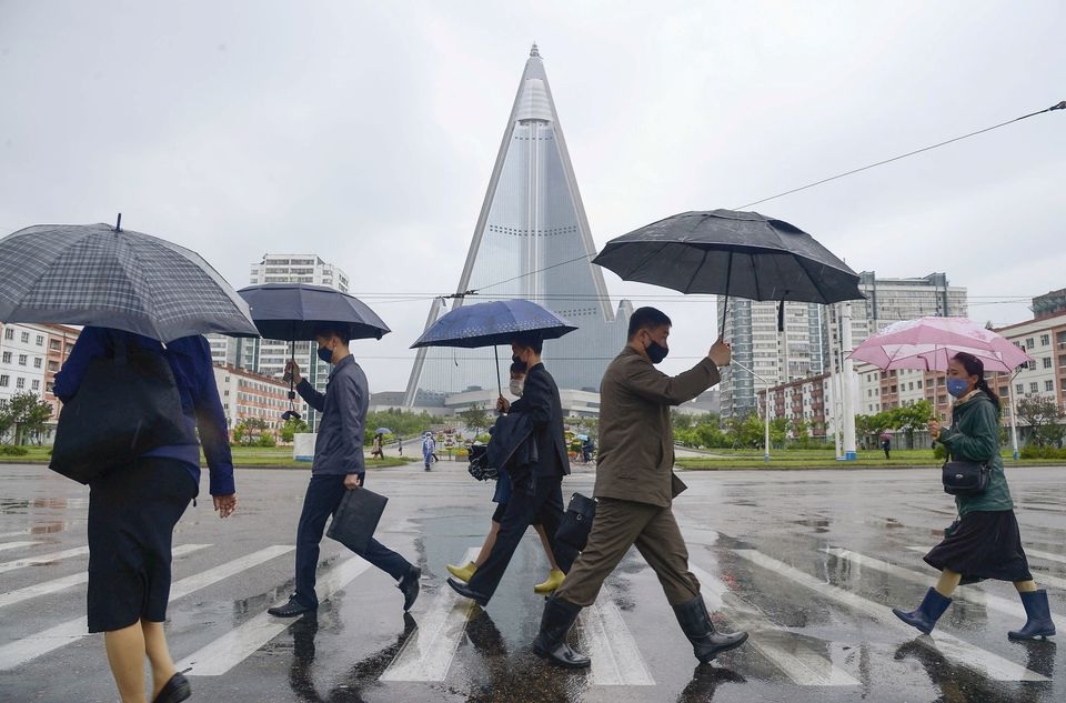 People wearing protective face masks walk amid concerns over the new coronavirus disease (COVID-19) in Pyongyang, North Korea May 15, 2020, in this photo released by Kyodo. Mandatory credit Kyodo/via REUTERS/File Photo


