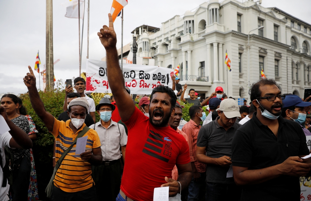 Anti-government demonstrators shout slogans during a protest demanding to arrest the supporters of the ruling party for storming an anti-government protest camp last week, outside the police headquarters, amid the country's economic crisis, in Colombo, Sri Lanka, May 16, 2022. REUTERS
