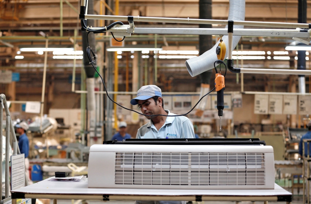 A worker assembles an air conditioner inside the Daikin Industries Ltd. plant at Neemrana in the desert Indian state of Rajasthan, October 1, 2014. REUTERS/Adnan Abidi/File Photo
