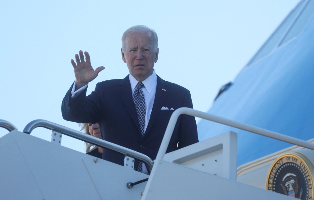 U.S. President Joe Biden waves while boarding Air Force One as he departs Washington on travel to Buffalo, New York in the wake of a weekend shooting at a Buffalo supermarket, at Joint Base Andrews in Maryland, U.S., May 17, 2022. REUTERS/Leah Millis