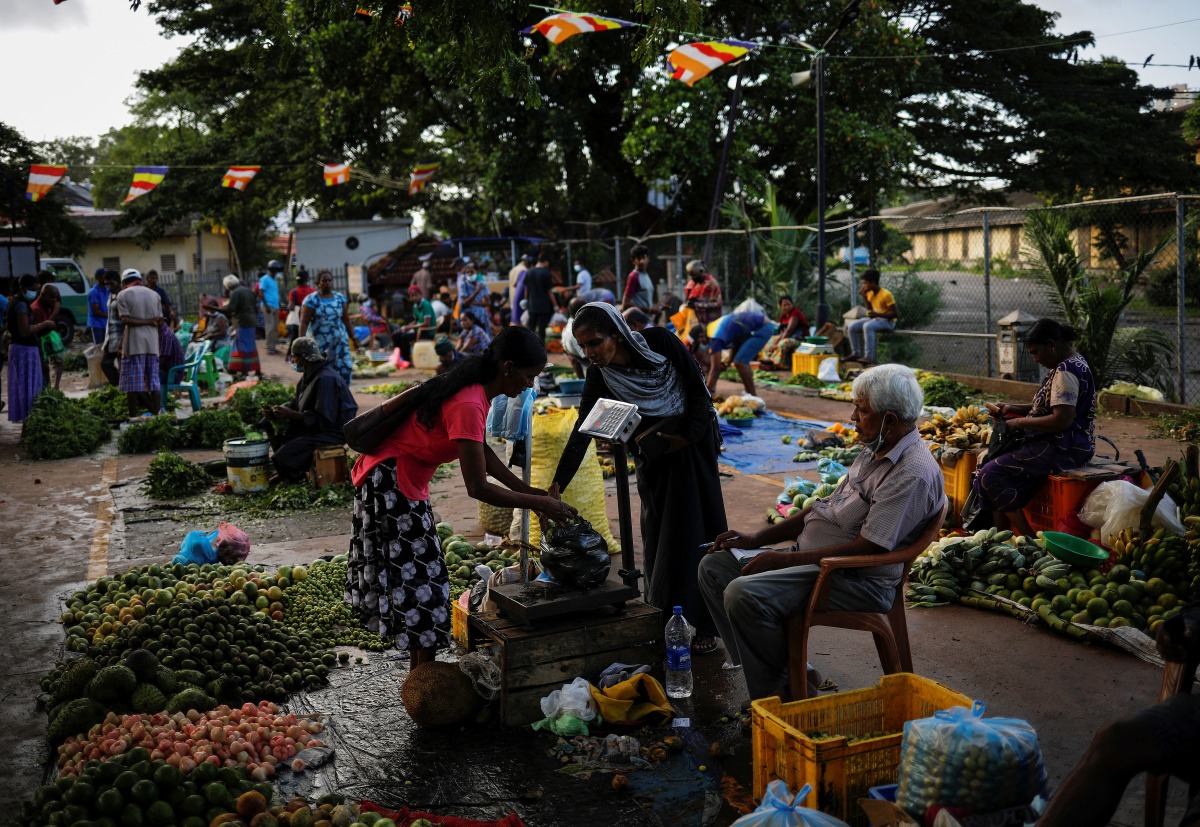 A vendor prepares a vegetables bag for a customer at a vegetable market, amid the country's economic crisis in Colombo, Sri Lanka, May 20, 2022. REUTERS/Adnan Abidi
