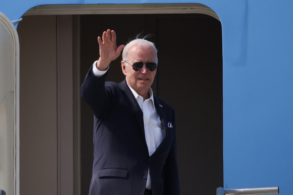 US President Joe Biden gestures as he departs for Japan at Osan Air Base in Pyeongtaek, South Korea, May 22, 2022. Reuters/Kim Hong-Ji/Pool
