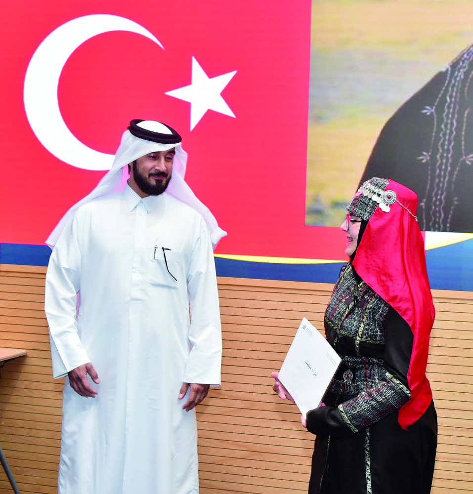 A graduate from Turkey receives a certificate.