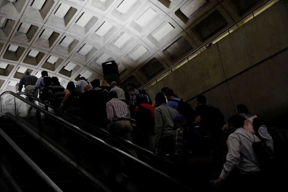 Commuters ride an escalator during the morning rush at the Metro Center subway station in Washington, U.S. June 12, 2017. REUTERS/Jonathan Ernst

