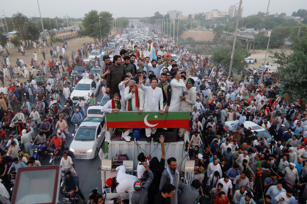 Ousted Pakistani Prime Minister Imran Khan gestures as he travels on a vehicle to lead a protest march in Islamabad, Pakistan May 26, 2022. REUTERS/Akhtar Soomro
