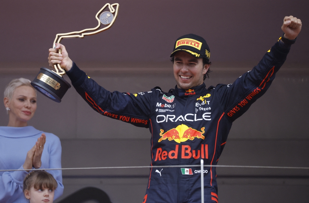 Red Bull's Sergio Perez celebrates with a trophy on the podium after winning the race as Princess Charlene of Monaco applauds REUTERS/Christian Hartmann
