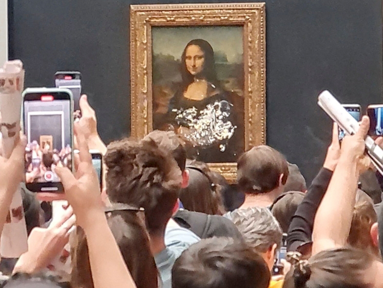 Visitors take pictures and video of the painting 