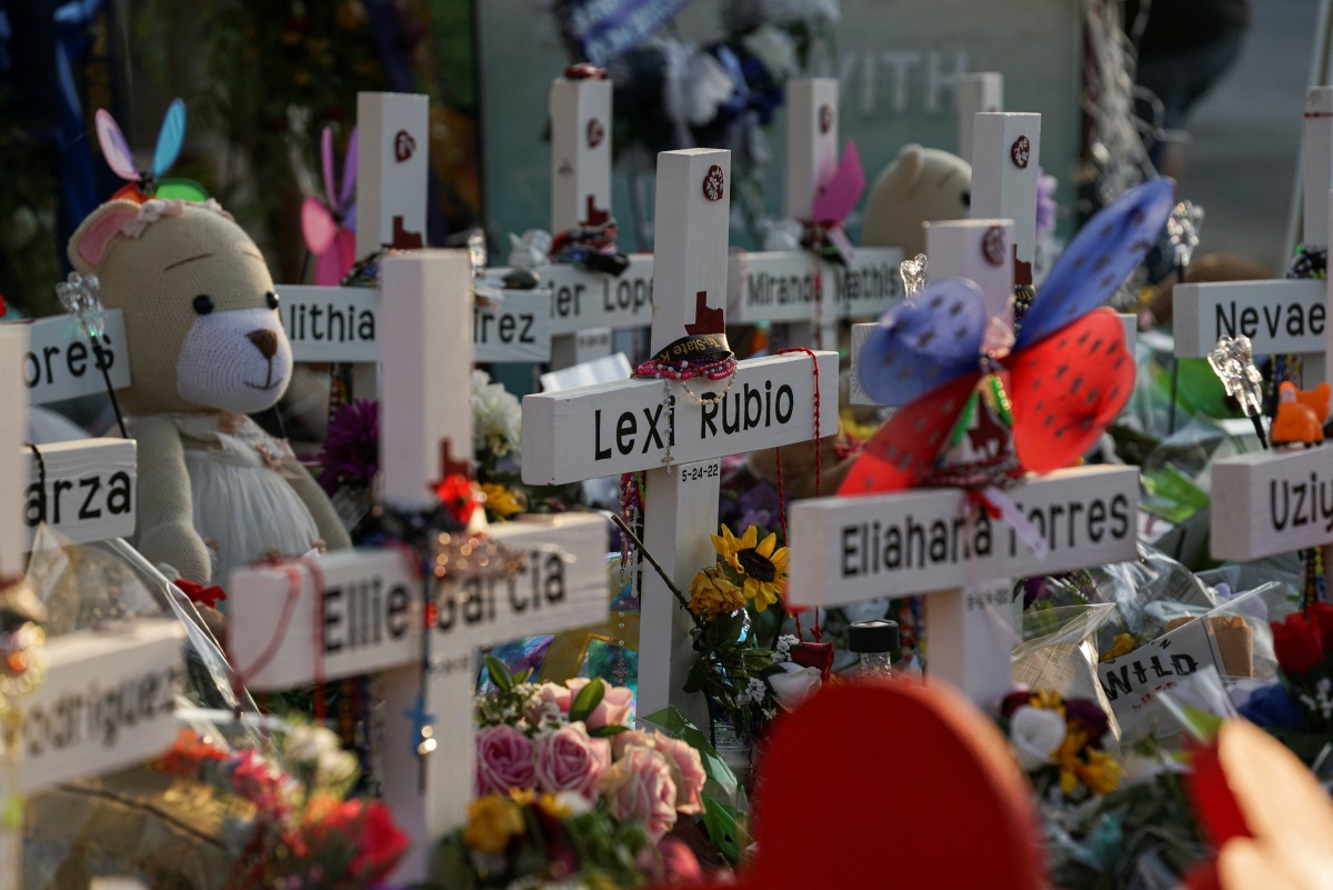 Flowers, toys, and other objects to remember the victims of the deadliest U.S. school mass shooting resulting in the death of 19 children and two teachers, are seen at a memorial at Robb Elementary School in Uvalde, Texas, U.S. May 30, 2022. Picture taken May 30, 2022. REUTERS/Veronica G. Cardenas
