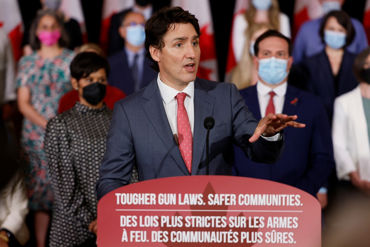 Canada's Prime Minister Justin Trudeau, with government officials and gun-control advocates, speaks at a news conference about firearm-control legislation that was tabled today in the House of Commons in Ottawa, Ontario, Canada May 30, 2022. REUTERS/Blair Gable
