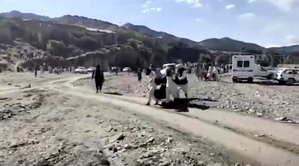 People carry injured to be evacuated following a massive earthquake, in Paktika Province, Afghanistan, June 22, 2022, in this screen grab taken from a video. BAKHTAR NEWS AGENCY
