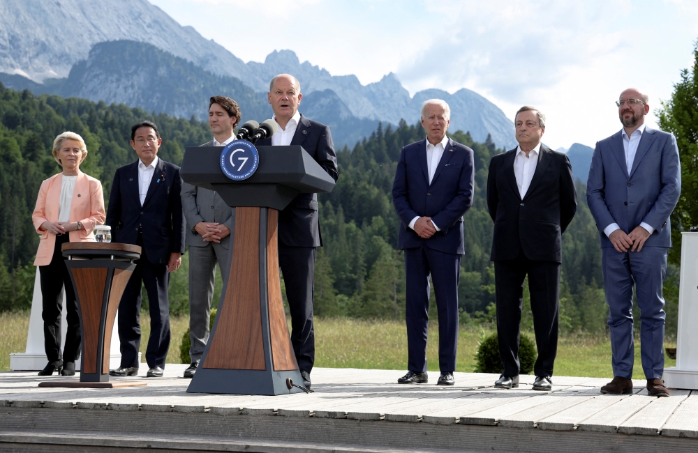 German Chancellor Olaf Scholz speaks next to European Commission President Ursula von der Leyen, Japanese Prime Minister Fumio Kishida, Canadian Prime Minister Justin Trudeau, US President Joe Biden, Italian Prime Minister Mario Draghi and European Council President Charles Michel during the first day of the G7 leaders' summit at Bavaria's Schloss Elmau castle, near Garmisch-Partenkirchen, Germany, on June 26, 2022. (Reuters/Lukas Barth/Pool)
