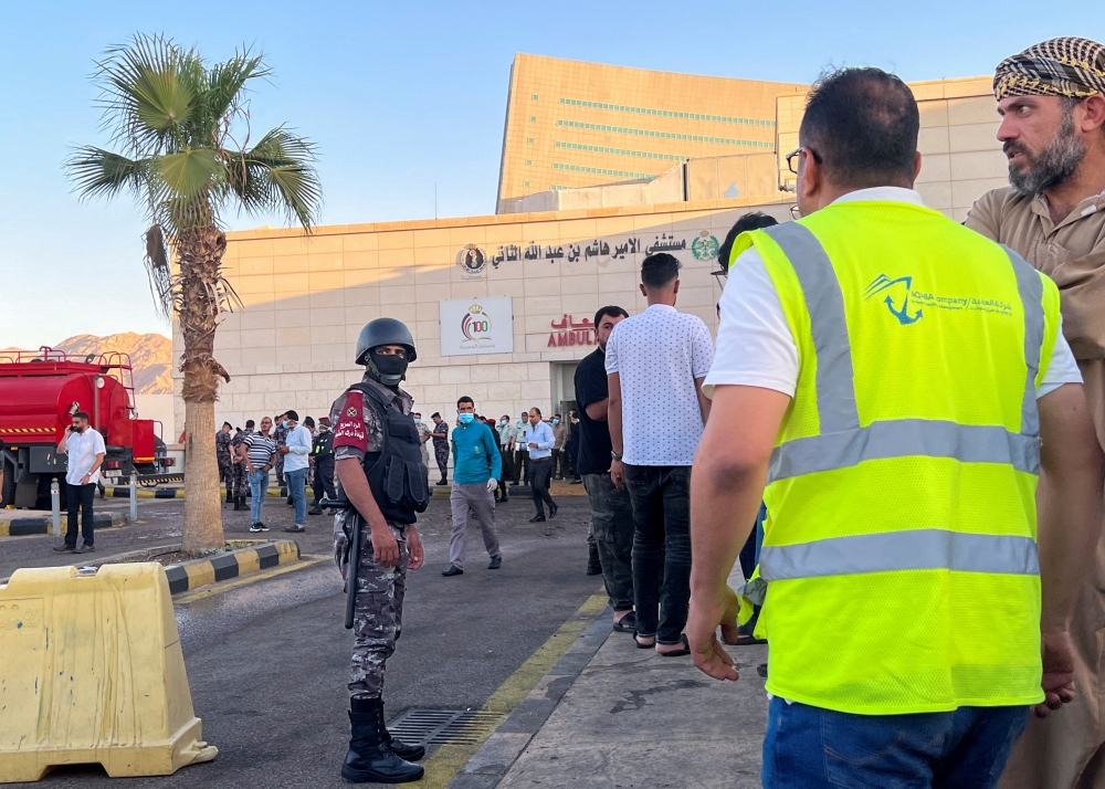 People stand outside a hospital after toxic gas leak from a storage tank in Jordan's Aqaba port, on June 27, 2022. (Reuters/Abraham Farajian)