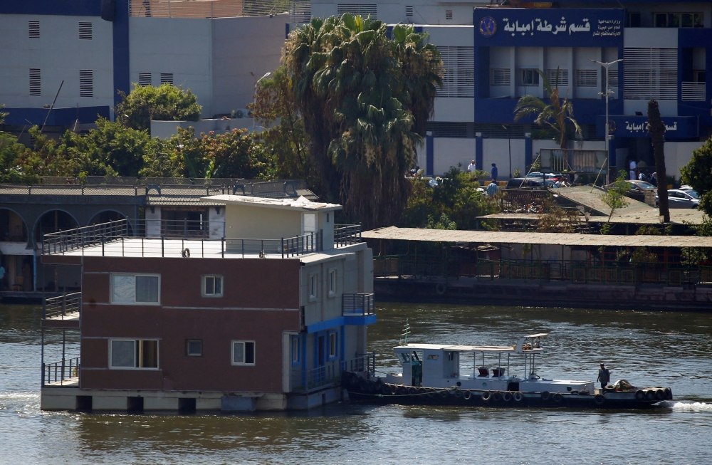 A government's boat pushes a houseboat on the River Nile, in Cairo, Egypt, on June 28, 2022. (Reuters/Amr Abdallah Dalsh)