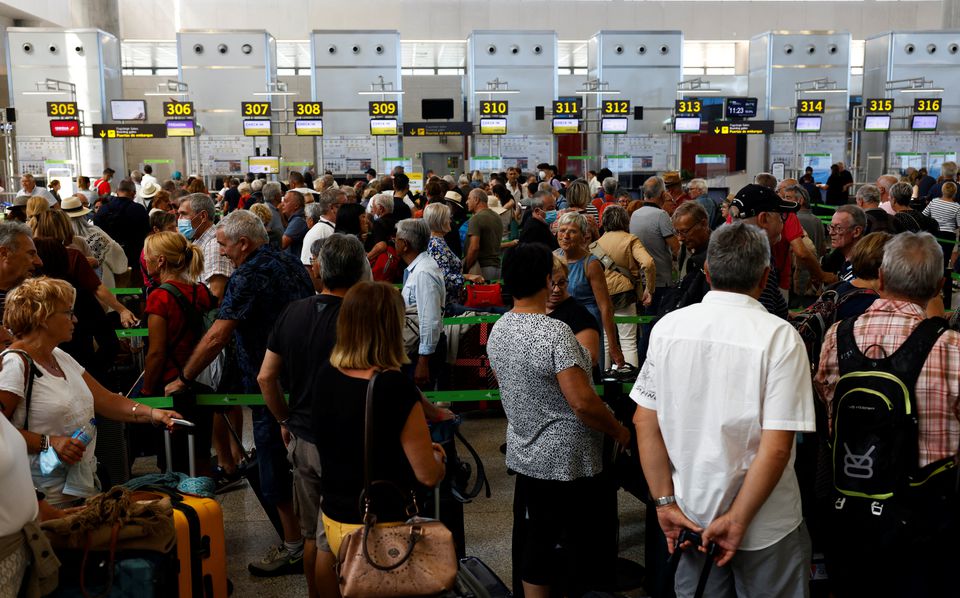 Passengers queue at check-in desks at Malaga-Costa del Sol Airport, in Malaga, Spain June 4, 2022. Reuters/Jon Nazca

