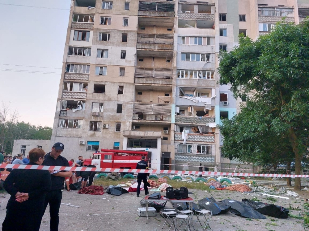 Bodies of civilian people killed by a Russian missile strike are seen in front of a damaged residential building, as Russia's attack on Ukraine continues, in the village of Serhiivka, Odesa region, Ukraine July 1, 2022. Press service of the State Emergency Service of Ukraine/Handout via REUTERS