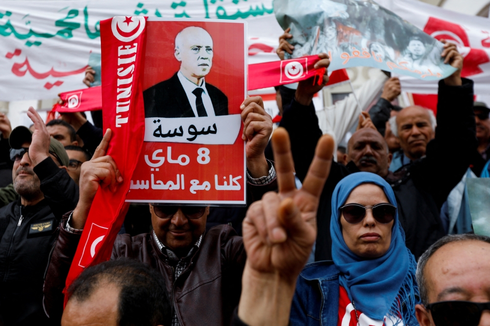 People carry banners and flags during a rally in support of Tunisian President Kais Saied in Tunis, Tunisia, on May 8, 2022. (Reuters/Zoubeir Souissi)