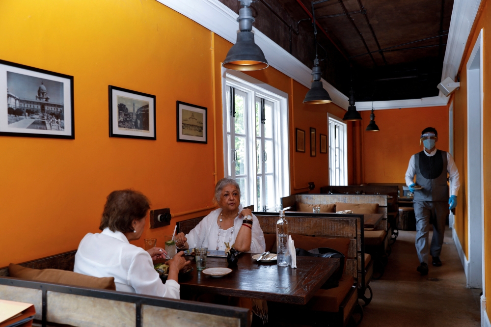 Women have lunch at a restaurant as India eases lockdown restrictions that were imposed to slow the spread of the coronavirus disease (COVID-19), in New Delhi, India, June 9, 2020. REUTERS/Anushree Fadnavis/File Photo