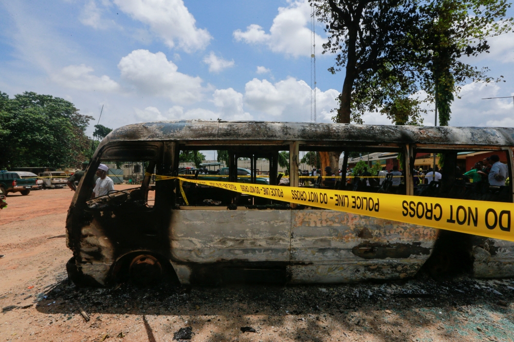 One of the prison buses burnt during the attack by several gunmen at the medium-security prison in Kuje, near the capital Abuja, Nigeria, July 6, 2022. (Reuters/Afolabi Sotunde)

