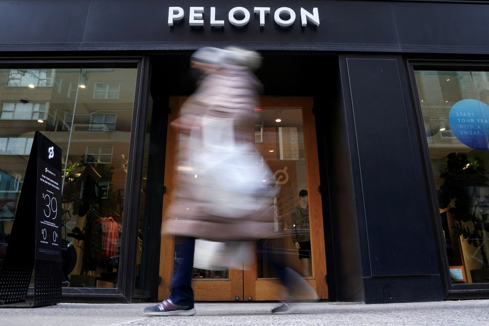 A person walks past a Peloton store in the Manhattan borough of New York City, U.S., January 25, 2022. REUTERS/Carlo Allegri/File Photo
