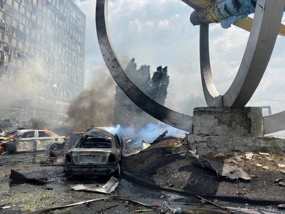 Destroyed vehicles are seen near a monument at the site of a Russian military strike, as Russia's attack on Ukraine continues, in Vinnytsia, Ukraine, July 14, 2022. (Reuters)

