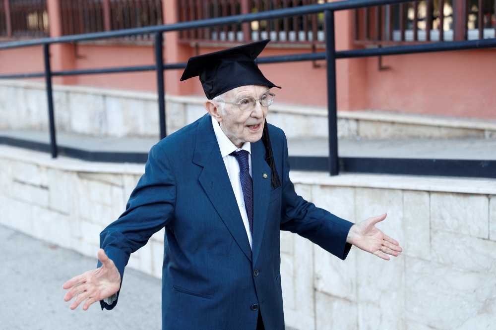 File Photo: Giuseppe Paterno celebrates after graduating from his undergraduate degree in history and philosophy during his graduation at the University of Palermo, in Palermo, Italy, July 29, 2020. (REUTERS/Guglielmo Mangiapane)
