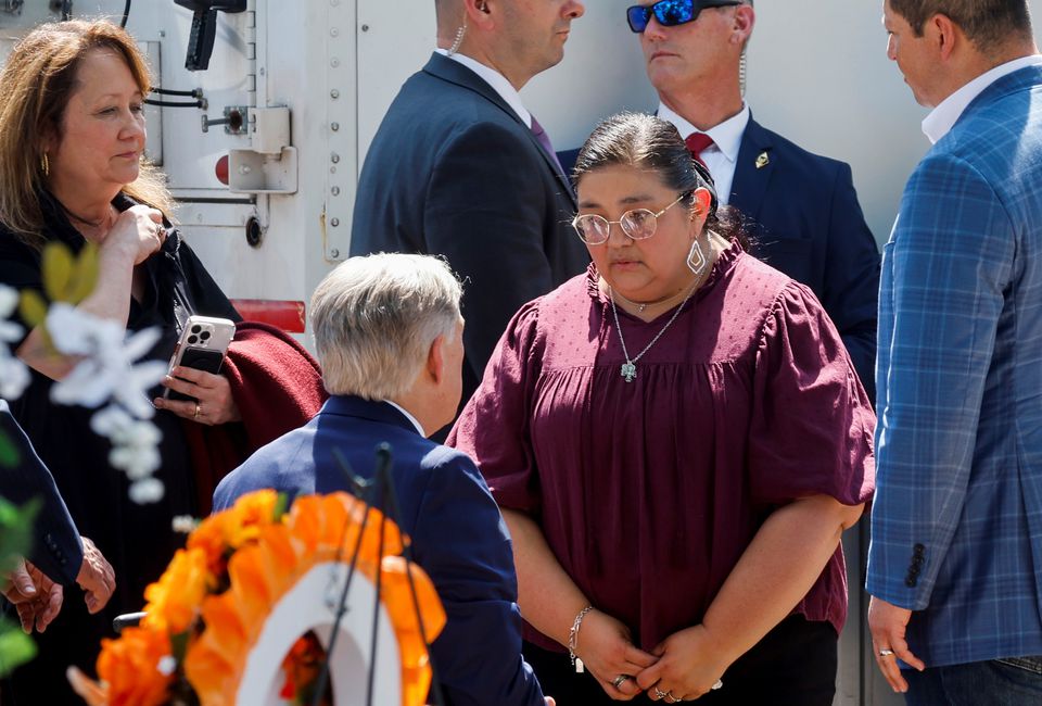Texas Governor Greg Abbott speaks with Mandy Gutierrez, Principal at Robb Elementary School, where a gunman killed 19 children and two teachers in the deadliest U.S. school shooting in nearly a decade, during U.S. President Joe Biden's visit at the school, in Uvalde, Texas, U.S. May 29, 2022. REUTERS/Jonathan Erns
