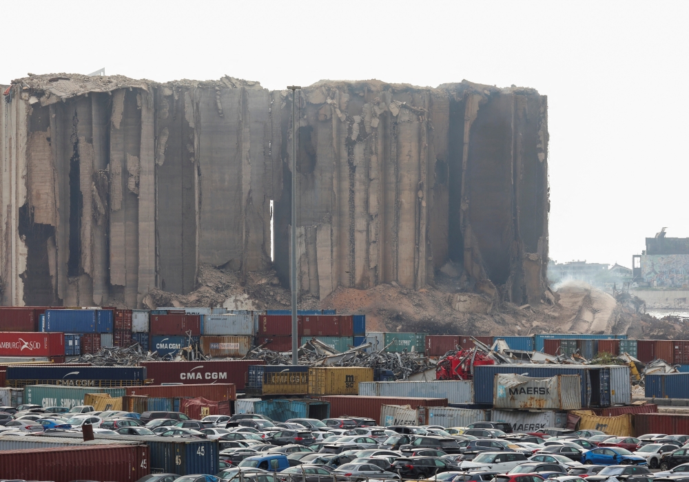 Dust rises as part of Beirut grain silos, damaged in the August 2020 port blast, collapses, in Beirut, Lebanon, on July 31, 2022. (REUTERS/Mohamed Azakir)