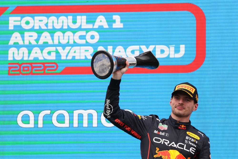 Red Bull's Max Verstappen celebrates on the podium with a trophy after winning the Hungarian Grand Prix in Hungaroring, Budapest, Hungary, July 31, 2022. (REUTERS/Bernadett Szabo)