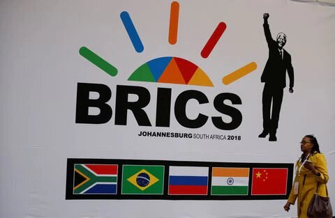 A delegate walks past a BRICS logo ahead of the 10th BRICS Summit, in Sandton, South Africa, July 24, 2018. REUTERS/Siphiwe Sibeko
