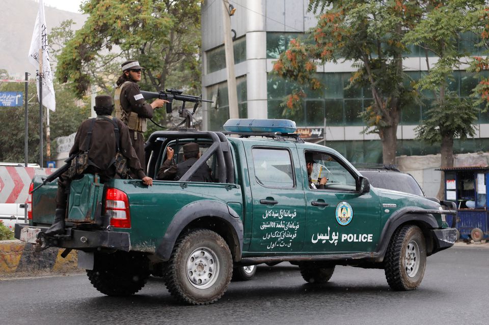 Taliban fighters drive a car on a street following the killing of Al Qaeda leader Ayman al-Zawahiri in a U.S. strike over the weekend, in Kabul, Afghanistan, August 2, 2022. REUTERS/Ali Khara/File Photo