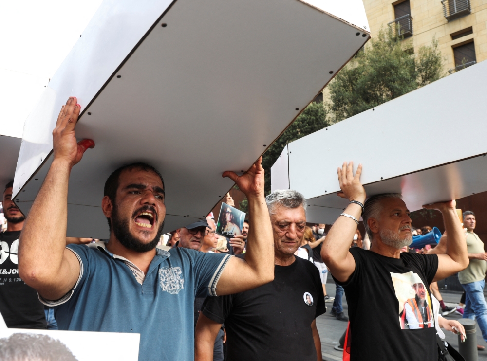 Demonstrators carry mockup coffins during a protest as Lebanon marks the two-year anniversary of the August 2020 Beirut port explosion, in Beirut, Lebanon August 4, 2022. (REUTERS/Mohamed Azakir)