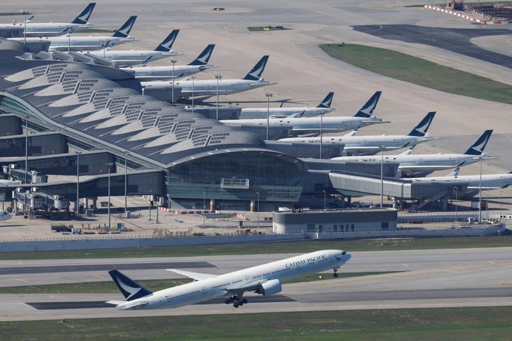 A Cathay Pacific aircraft takes off at the airport, during the coronavirus disease (COVID-19) pandemic, in Hong Kong, China, March 31, 2022. REUTERS/Tyrone Siu/File Photo GLOBAL BUSINESS WEEK AHEAD