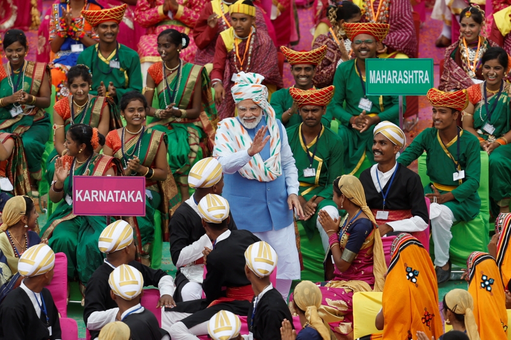Indian Prime Minister Narendra Modi meets with folk artists after addressing the nation during Independence Day celebrations at the historic Red Fort in Delhi, India, August 15, 2022. (REUTERS/Adnan Abidi)