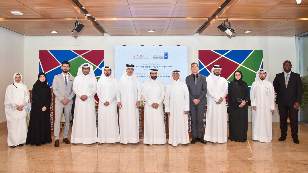 Silatech and UDST officials pose during the collaboration agreement signing ceremony.