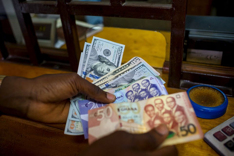 A man trades U.S. dollars for Ghanaian cedis at a currency exchange office in Accra, Ghana, File. REUTERS/Francis Kokoroko

