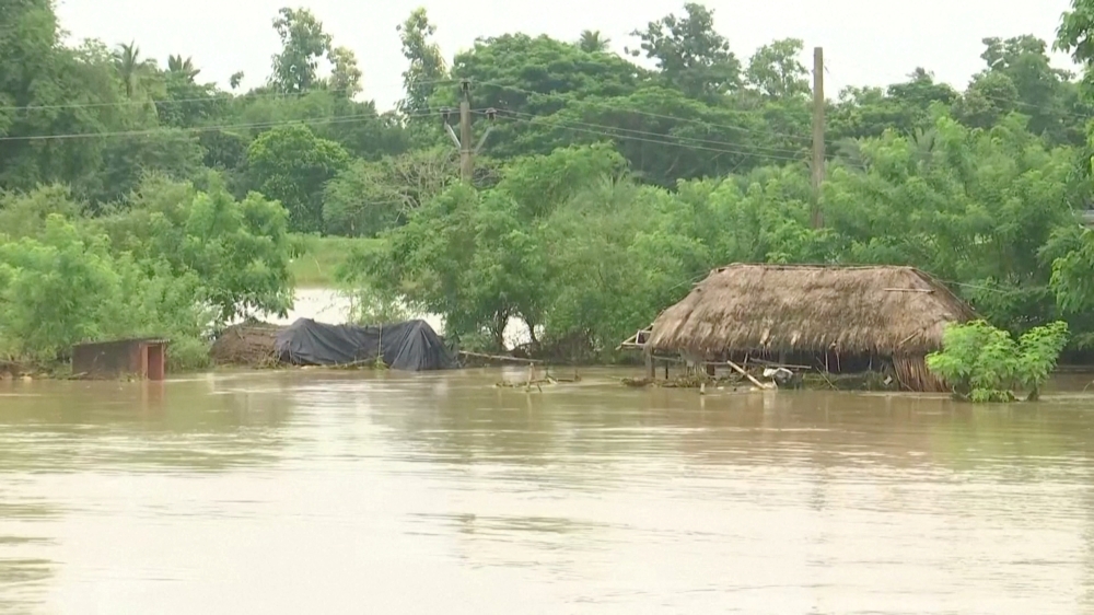 Huts get partially submerged in floodwater following heavy rains in Jagatsinghpur, Odisha, India August 20, 2022, in this screen grab obtained from a video. ANI via Reuters