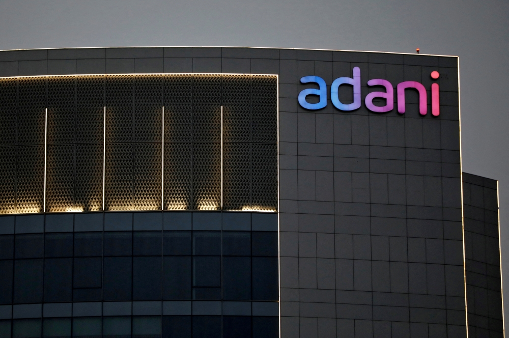 The logo of the Adani Group is seen on the facade of one of its buildings on the outskirts of Ahmedabad, India, on April 13, 2021. REUTERS/Amit Dave/File Photo