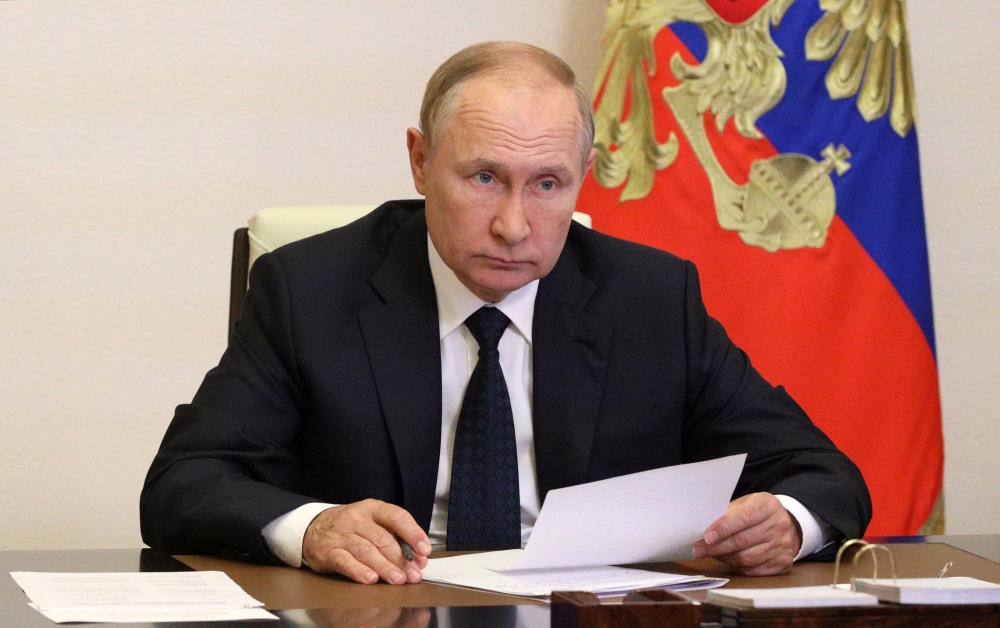 Russian President Vladimir Putin takes part in a televised meeting with officials to discuss forest fires at a residence outside Moscow, Russia, August 24, 2022. (Sputnik/Mikhail Klimentyev/Kremlin via REUTERS)