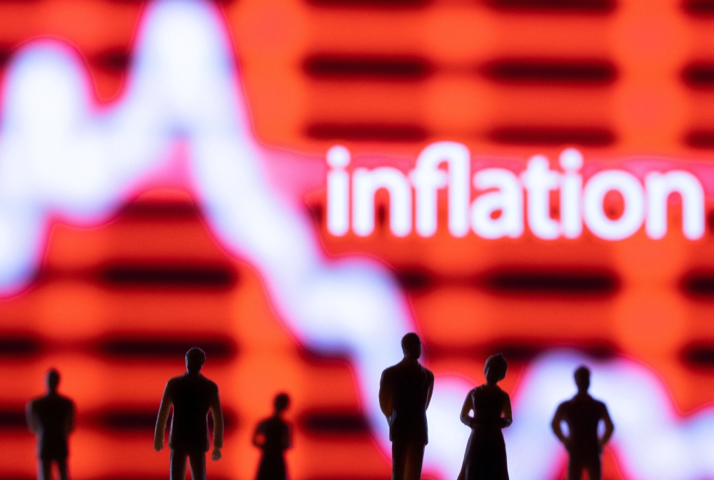 Figurines are seen in front of displayed stock graph and word 