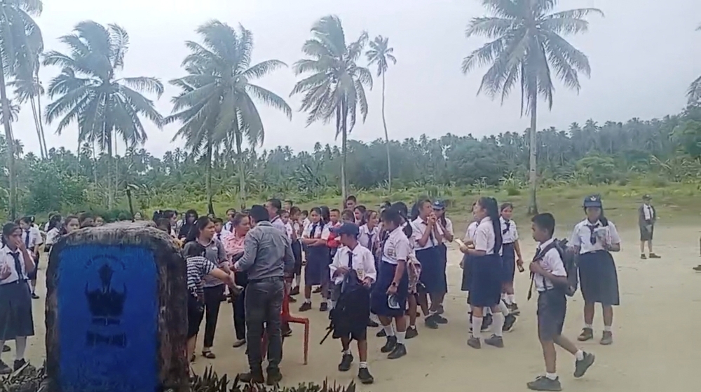 School students and staff gather in an open area after a magnitude 6.4 earthquake struck near Mentawai Islands, in South Nias, North Sumatra, Indonesia August 29, 2022 in this screen grab obtained from a social media video. Facebook/Doniman Aro Harefa/via REUTERS