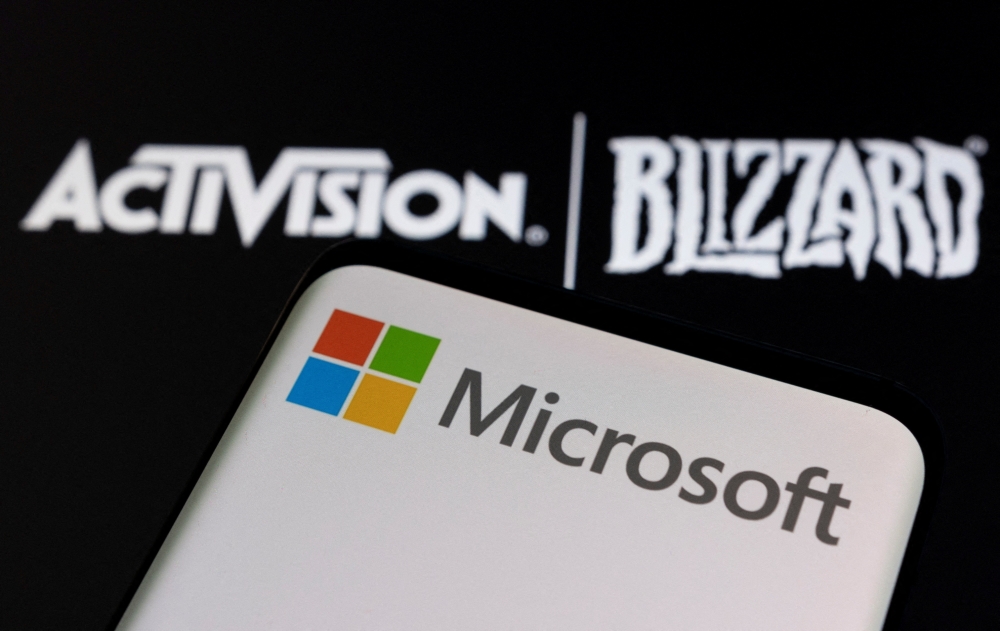 Microsoft logo is seen on a smartphone placed on displayed Activision Blizzard logo in this illustration taken on January 18, 2022. REUTERS/Dado Ruvic/Illustration/File Photo