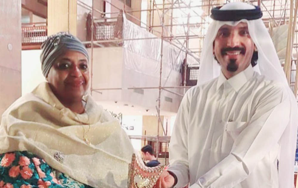 H E Ambassador Fatma Mohammed Rajab receiving a gift from Farhan Al Sheikh Al Sayed. 