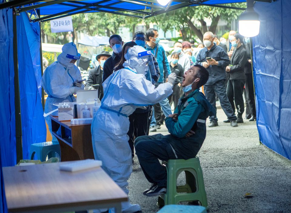 People line up at a makeshift nucleic acid testing site near a residential compound under lockdown following local cases of the coronavirus disease in Chengdu, Sichuan province, on November 3, 2021. cnsphoto via REUTERS