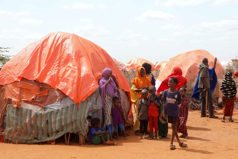 Civilians gather outside their makeshift shelters at the Kaxareey camp for the internally displaced people in Dollow, Gedo region of Somalia May 24, 2022. (REUTERS/Feisal Omar)