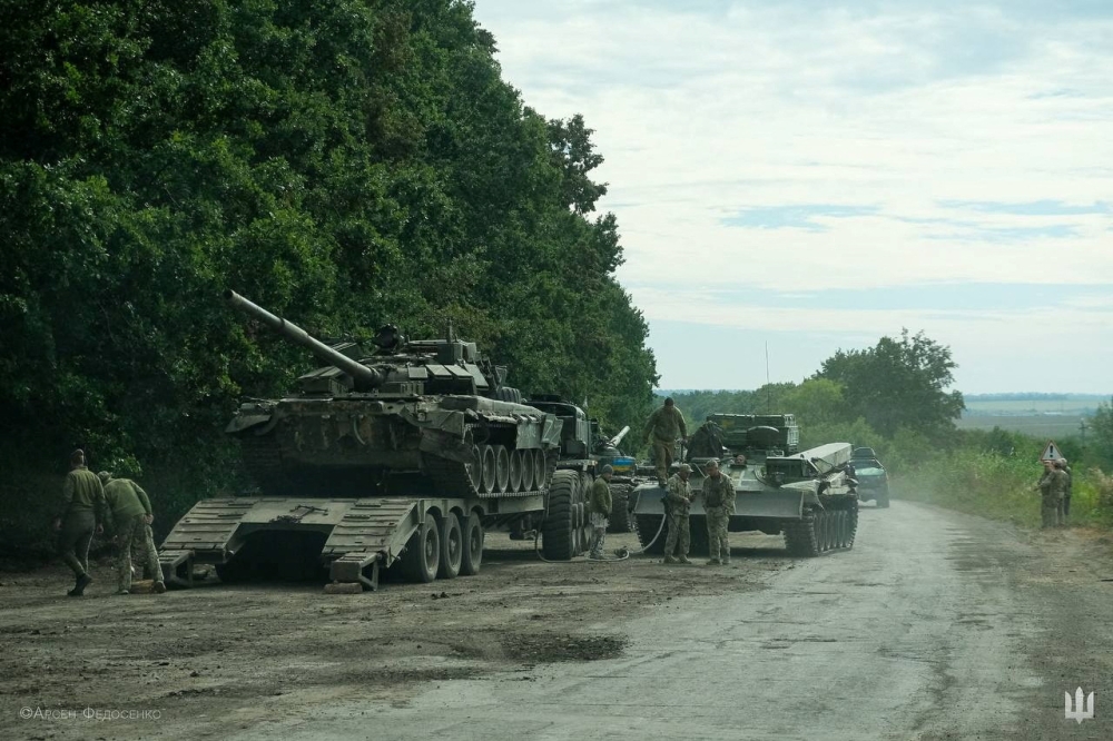 Ukrainian service members prepare to transport a Russian tank captured during a counteroffensive operation in Kharkiv region, Ukraine, in this handout picture released September 11, 2022. Press service of the Commander-in-Chief of the Armed Forces of Ukraine/Handout via Reuters
