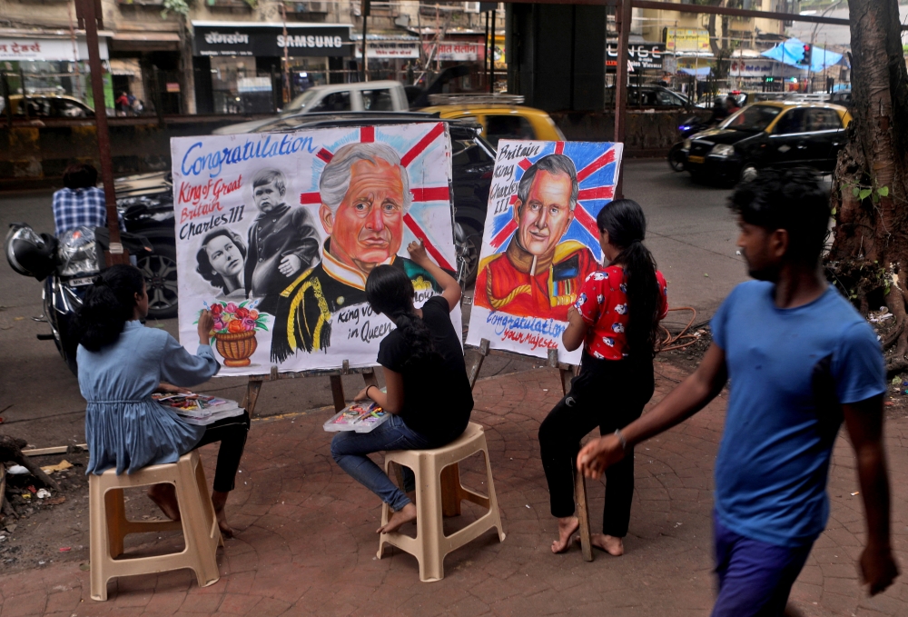 Students apply finishing touches to portraits of Britain's King Charles outside an art school in Mumbai, India, on September 11, 2022. REUTERS/Niharika Kulkarni