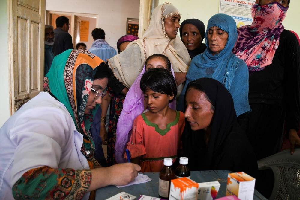 Flood victims receive medical assistance at a medical camp, following rains and floods during the monsoon season, in Manjhand town, in Jamshoro, Pakistan, on September 12, 2022. (REUTERS/Yasir Rajput)