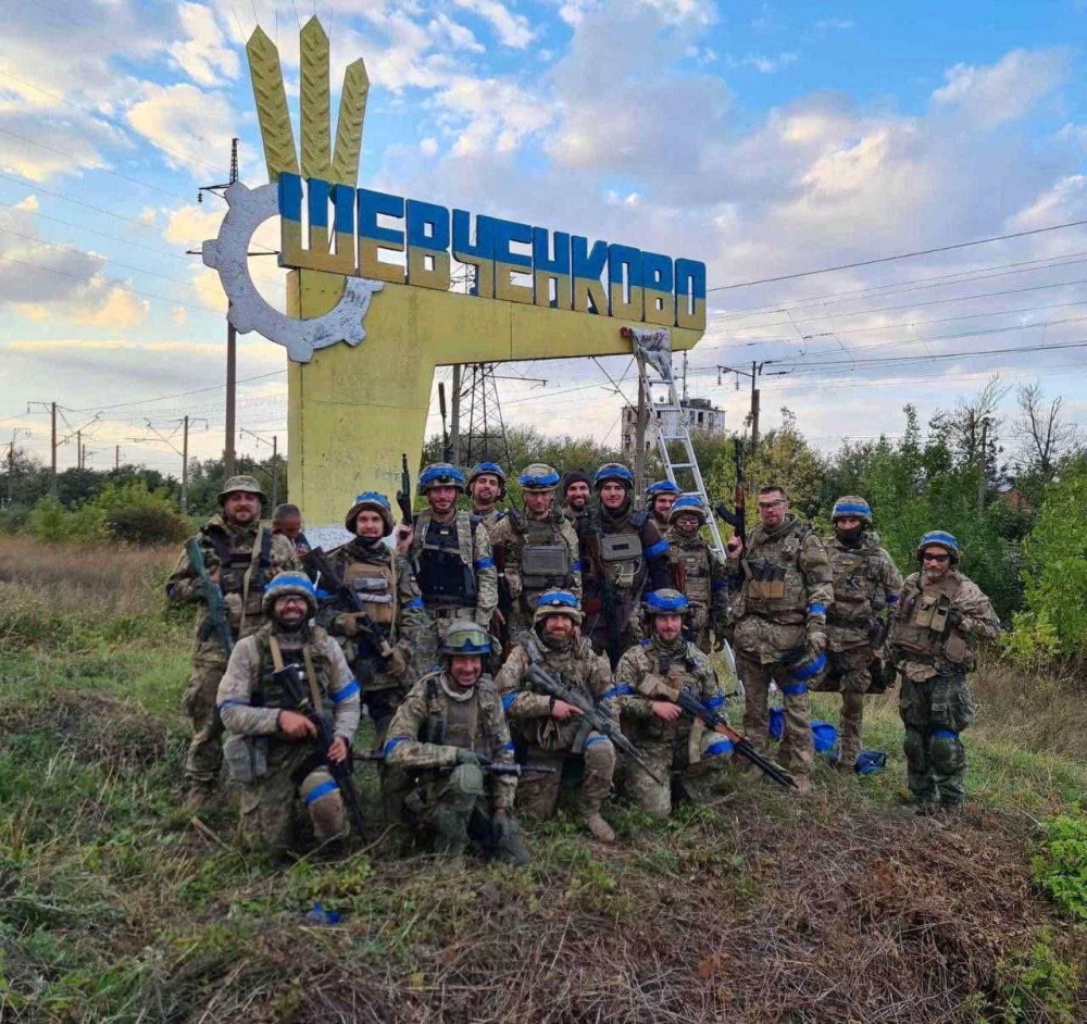 Ukrainian service members pose for in the recently liberated settlement of Shevchenkove, Ukraine amid Russia's attack on the country, in this handout picture released on September 10, 2022. Press service of the Territorial Defence of the Ukrainian Armed Forces/Handout via REUTERS