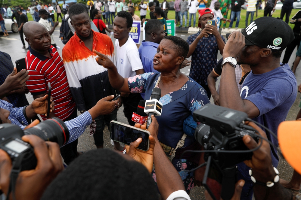 A demonstrator speaks to the press as members of the National Association of Nigerian Students (NANS) staged a protest against prolonged strike action of the Academic Staff Union of Universities at the access road to the Murtala Muhammad International Airport in Lagos, Nigeria, on September 19, 2022. REUTERS/Temilade Adelaja